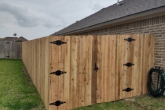 cedar-privacy-fence-with-ornamental-iron-hinge-gate
